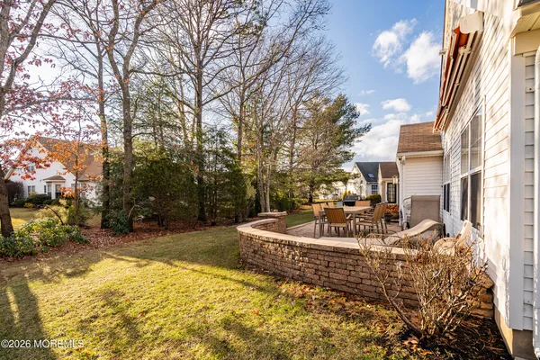 a view of a house with backyard and sitting area