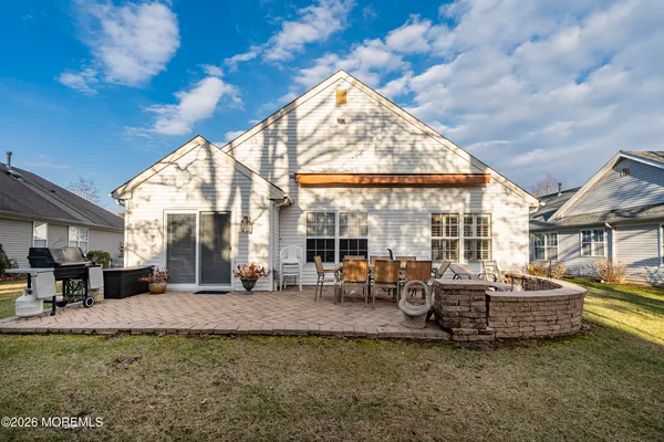 a view of a house with couches chairs and a fire pit
