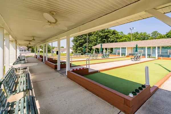 a view of a swimming pool with outdoor seating and a patio