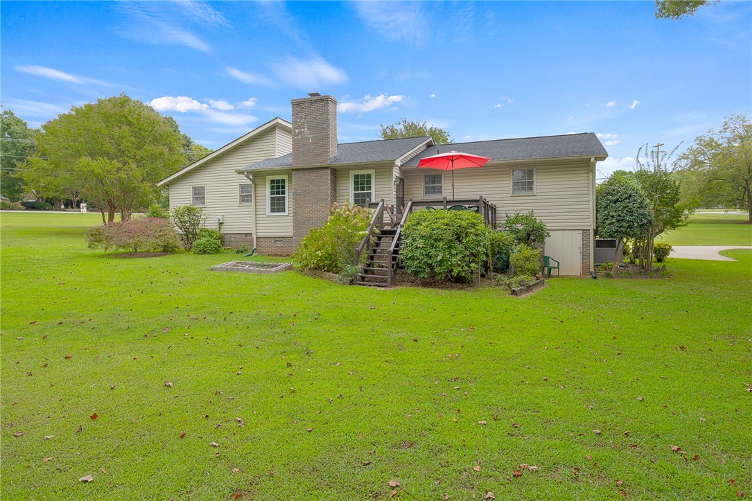 131 Bowen Road Anderson, SC 29621 - Photo 29 of 36 An expansive green lawn stretches toward the rear of this classic siding home with deck.