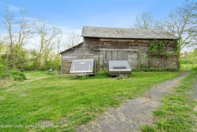 a front view of house with yard and trees