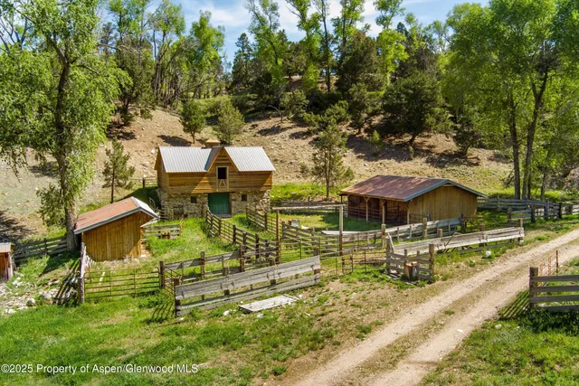 an aerial view of a house with swimming pool garden and patio