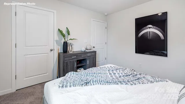 a bedroom with a bed and a television