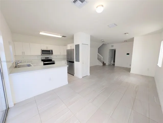 a kitchen with cabinets and white appliances