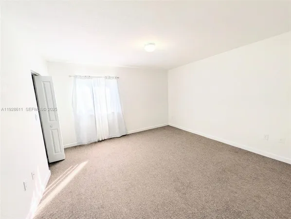 a view of an empty room and a window