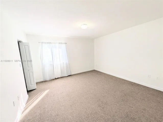 a view of an empty room and a window