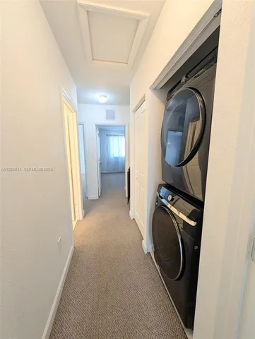a view of a hallway with washer and dryer