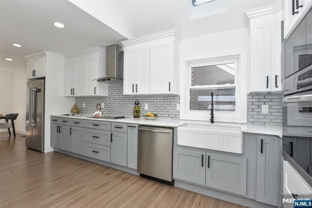 100 Chestnut Street Rochelle Park, NJ 07662 - Photo 12 of 42 a kitchen with white cabinets sink and stainless steel appliances