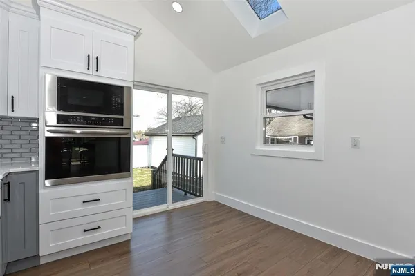 a kitchen with a microwave and a stove top oven