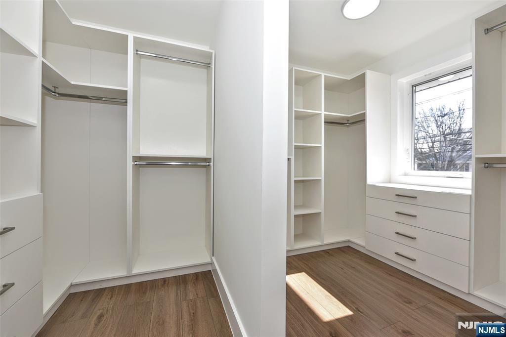 100 Chestnut Street Rochelle Park, NJ 07662 - Photo 18 of 42 a view of walk in closet with wooden floor