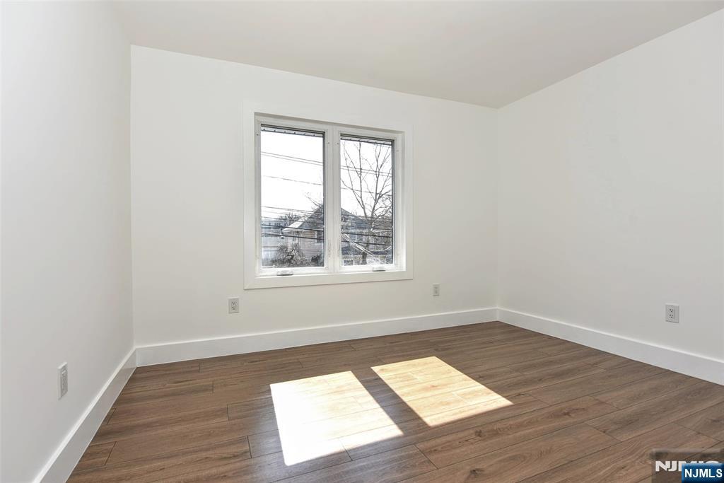 100 Chestnut Street Rochelle Park, NJ 07662 - Photo 19 of 42 an empty room with wooden floor and windows
