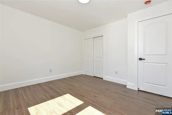 an empty room with wooden floor