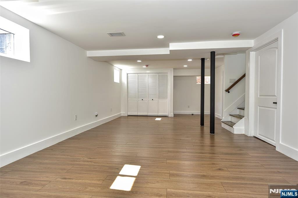 100 Chestnut Street Rochelle Park, NJ 07662 - Photo 27 of 42 a view of an empty room with wooden floor and a large window