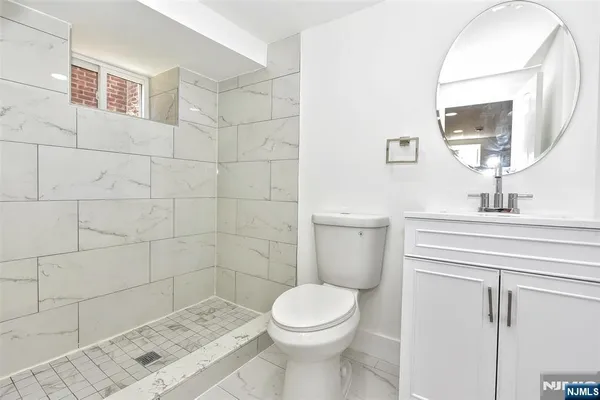 a bathroom with a sink a toilet and mirror