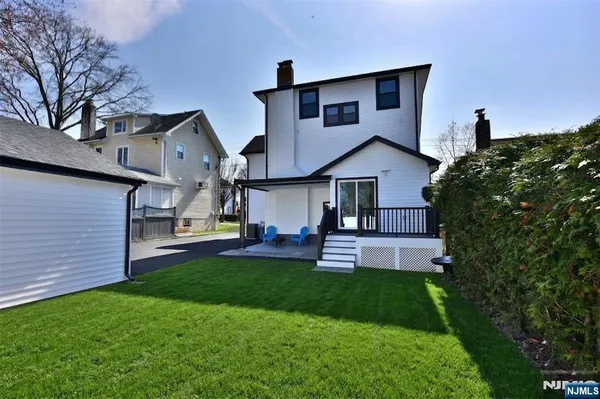 a front view of a house with a yard and deck