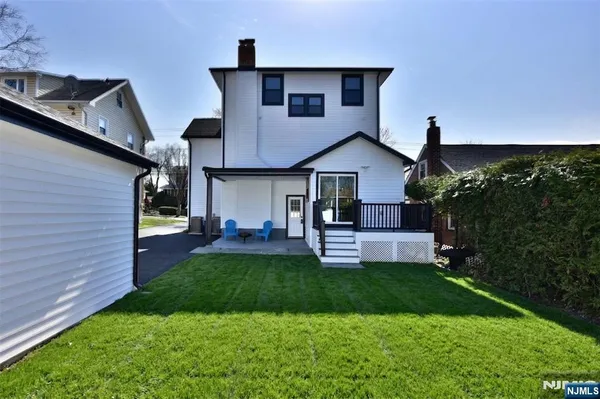 a front view of a house with a yard porch and outdoor seating