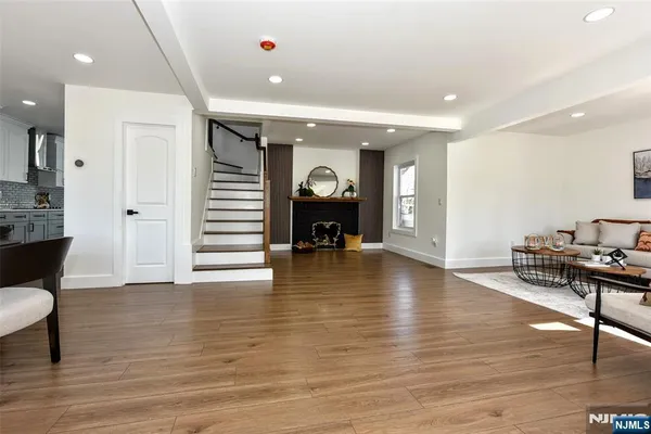 a view of a living room a dining room wooden floor and a fireplace