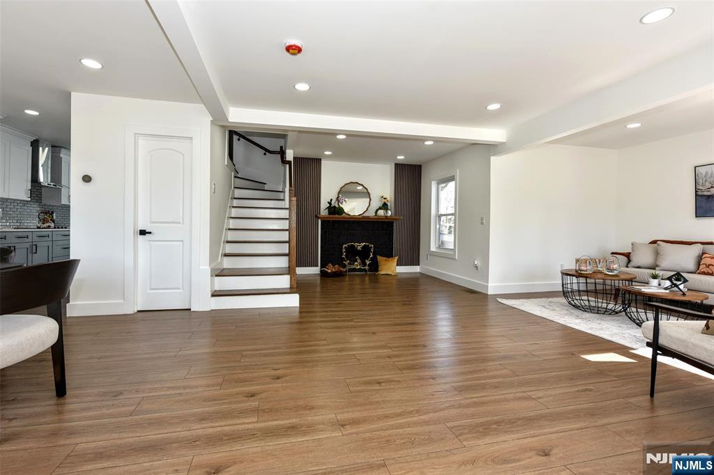 100 Chestnut Street Rochelle Park, NJ 07662 - Photo 4 of 42 a view of a living room a dining room wooden floor and a fireplace