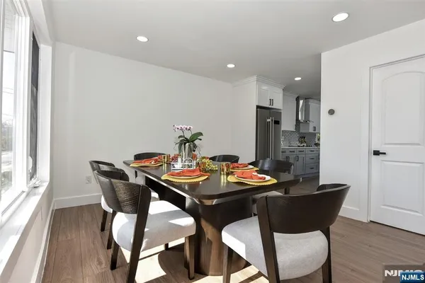 a view of a dining room with furniture and wooden floor