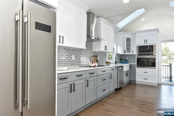 a kitchen with white cabinets and white appliances