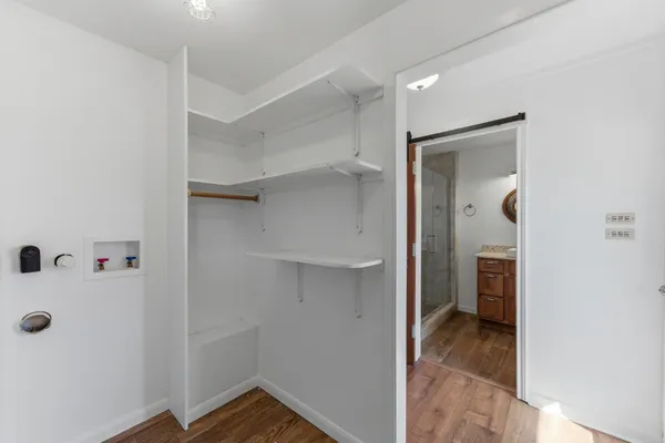 a bathroom with a granite countertop sink a mirror and a shower