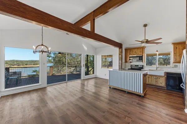 a view of livingroom with furniture wooden floor fireplace and windows