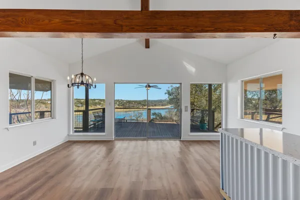 a view of a room with wooden floor and floor to ceiling window