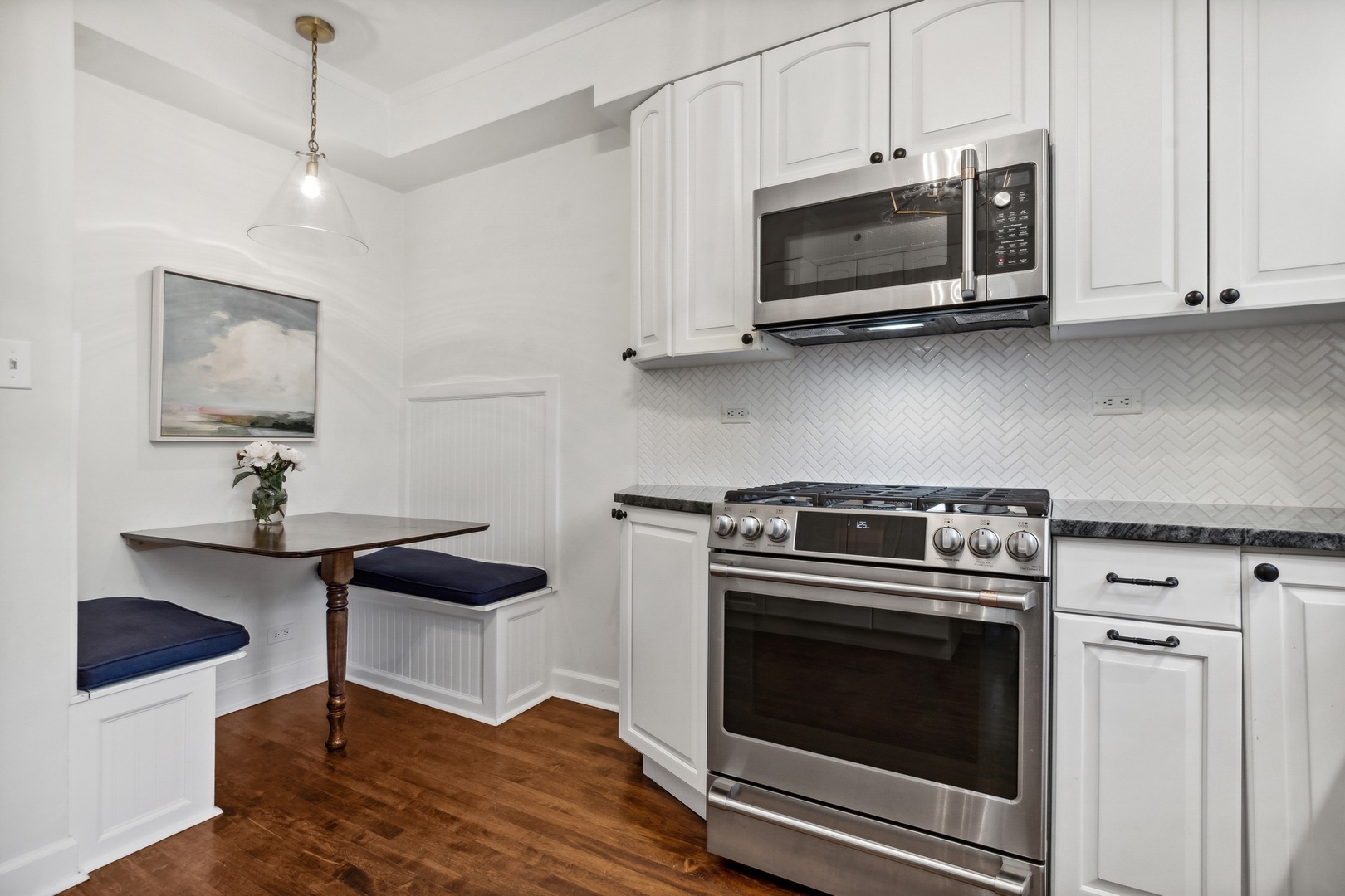 235 Church Road Winnetka, IL 60093 - Photo 12 of 27 a kitchen with stainless steel appliances a stove a microwave and cabinets