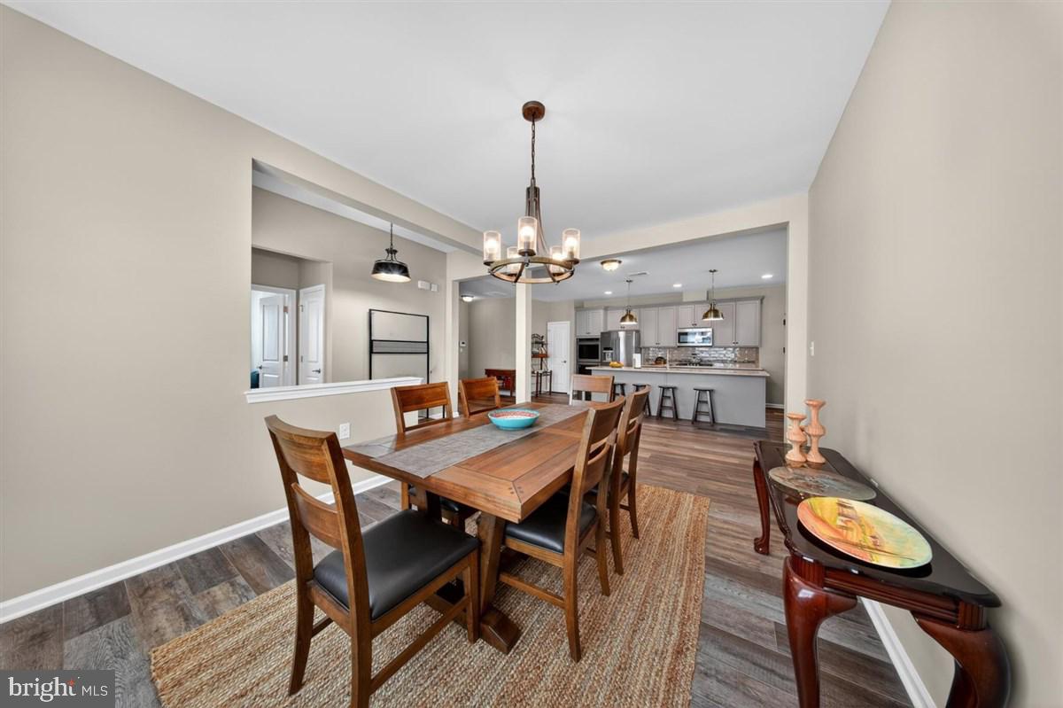 1426 Whispering Woods Road Middletown, DE 19709 - Photo 6 of 37 a view of a dining room with furniture and wooden floor