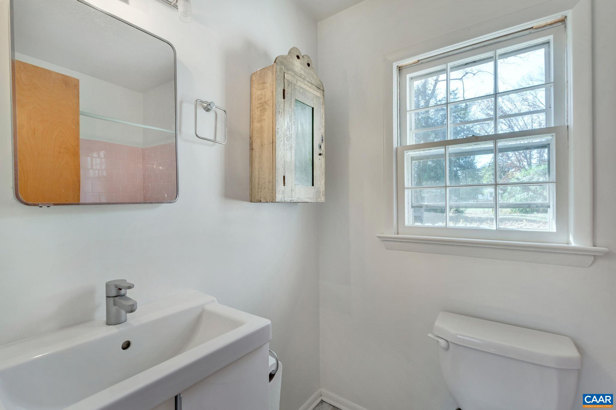 1406 Holly Road Charlottesville, VA 22901 - Photo 18 of 62 a bathroom with a toilet sink and mirror