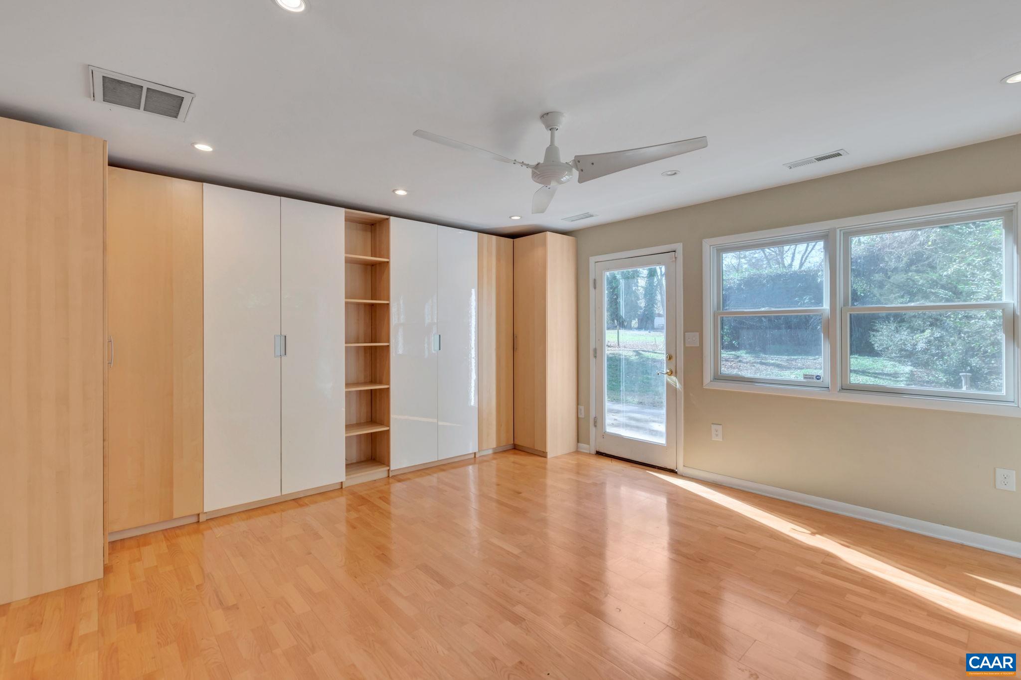 1406 Holly Road Charlottesville, VA 22901 - Photo 35 of 62 an empty room with wooden floor and windows
