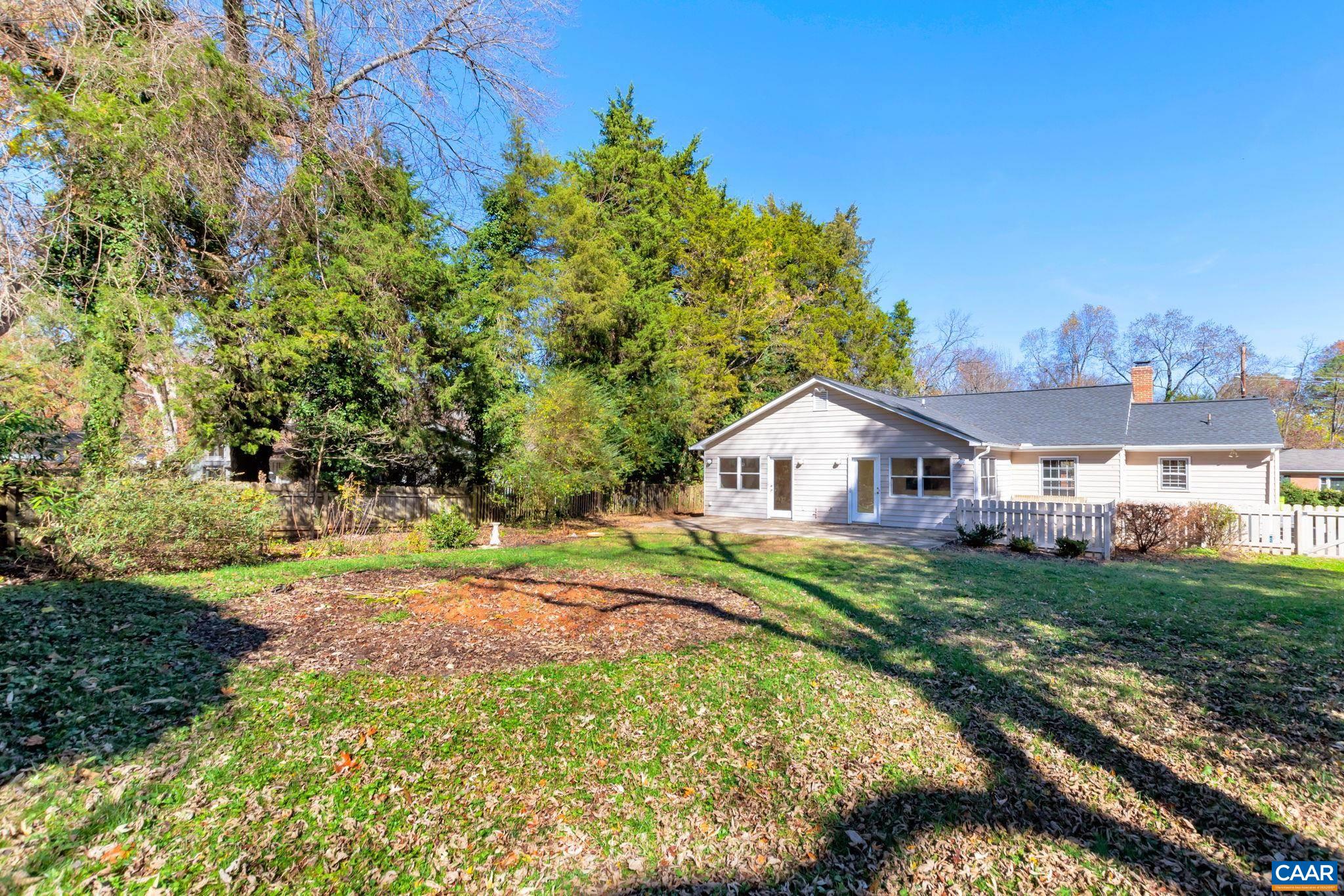 1406 Holly Road Charlottesville, VA 22901 - Photo 50 of 62 a front view of a house with a yard and trees