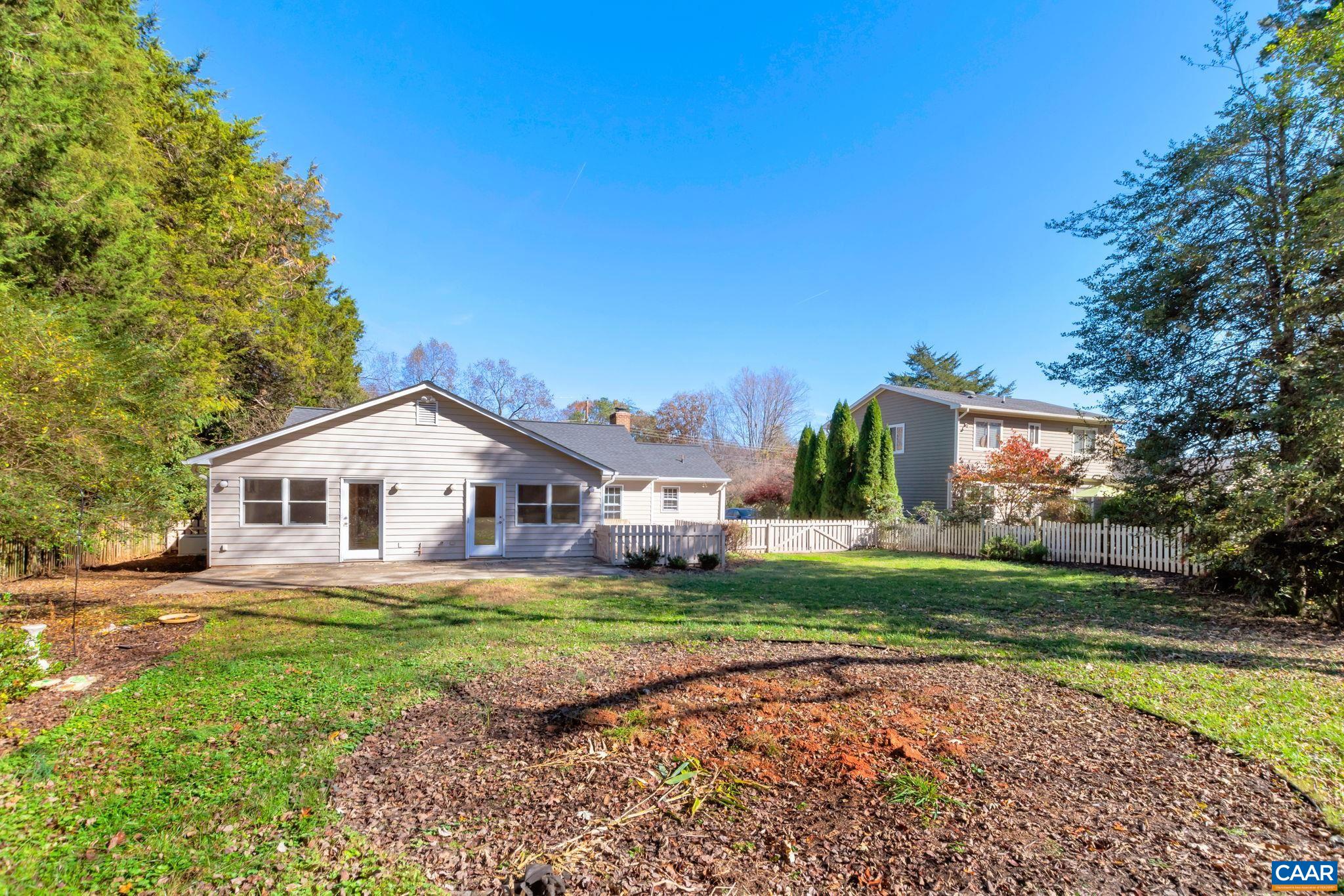 1406 Holly Road Charlottesville, VA 22901 - Photo 54 of 62 a view of a house with a big yard and large trees