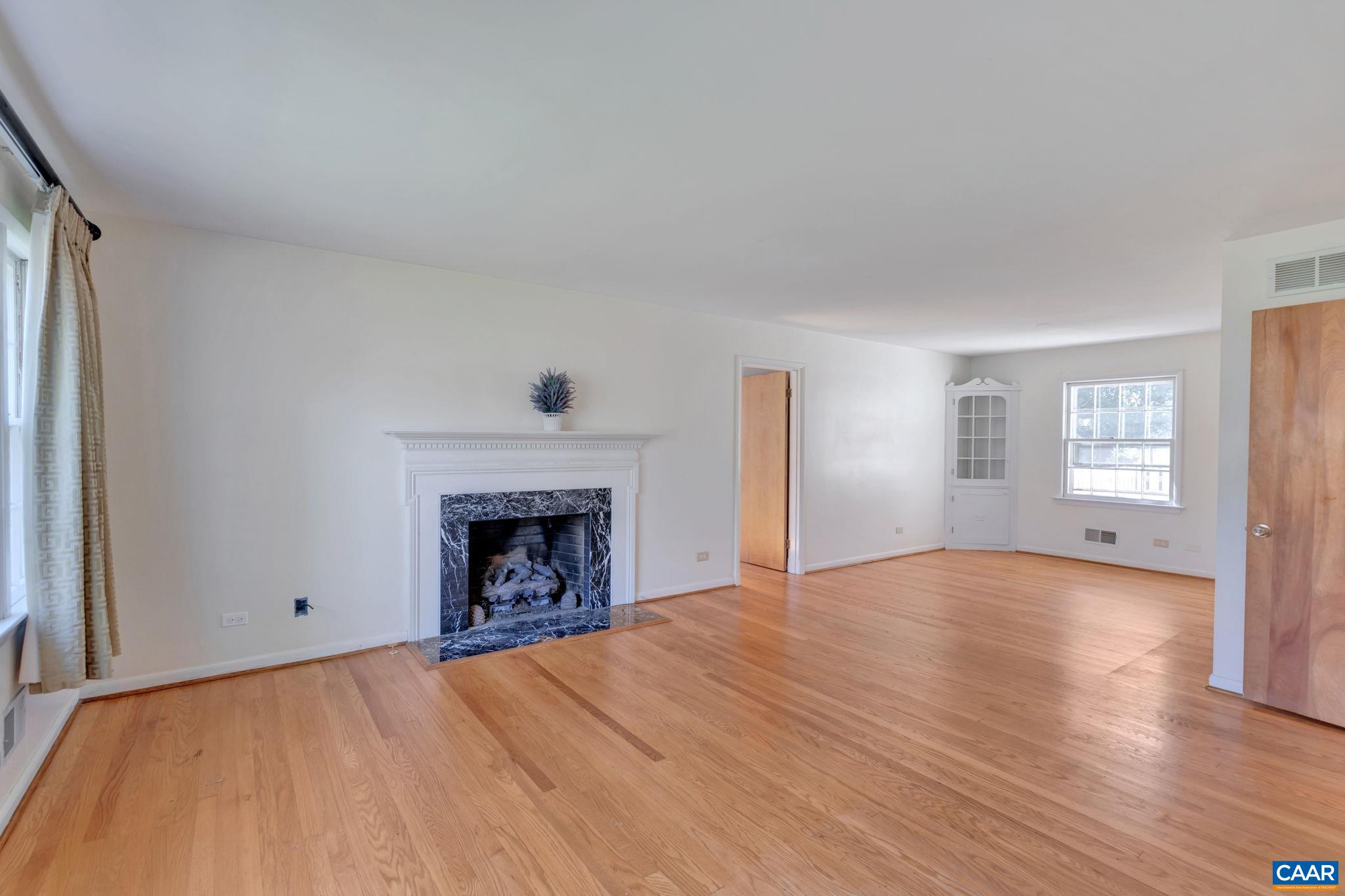 1406 Holly Road Charlottesville, VA 22901 - Photo 7 of 62 a view of an empty room with window and fire place