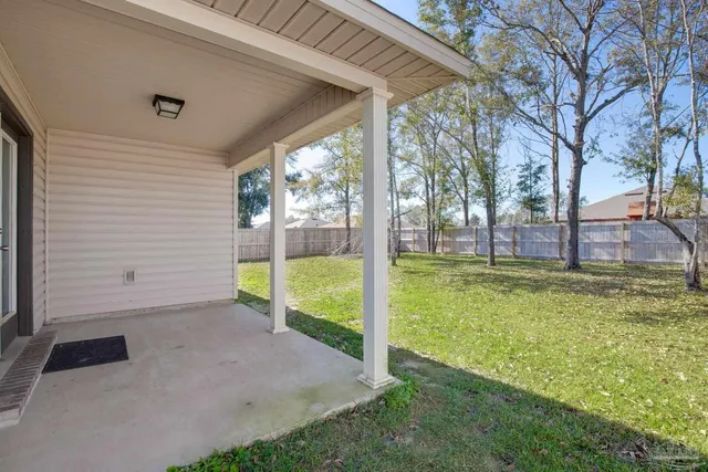 a view of a backyard with large tree