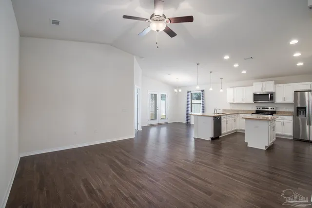 a view of kitchen with table and chairs