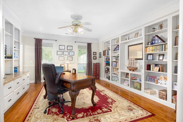 a living room with furniture a rug and a fireplace