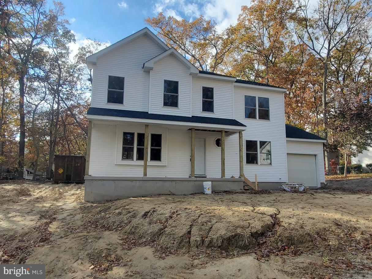 15 Vine Street Browns Mills, NJ 08015 - Photo 2 of 3 a view of a white house with a yard