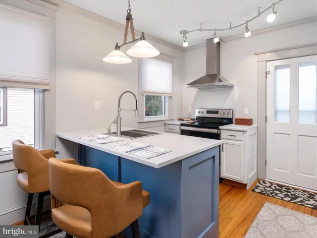 a kitchen with stainless steel appliances granite countertop a sink a stove and a refrigerator