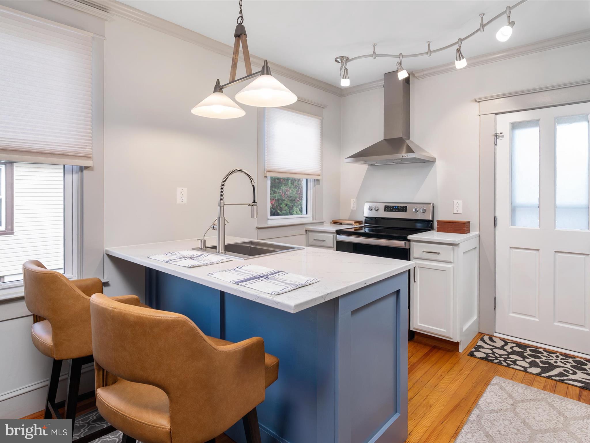 3669 Hineline Road Baltimore, MD 21229 - Photo 12 of 33 a kitchen with stainless steel appliances granite countertop a sink a stove and a refrigerator