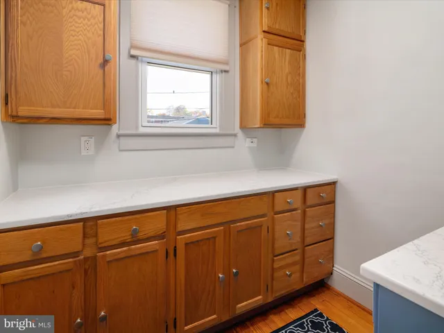 a kitchen with stainless steel appliances granite countertop cabinets and window