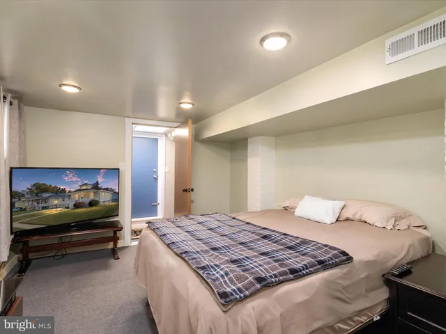 a bedroom with a bed and a couch