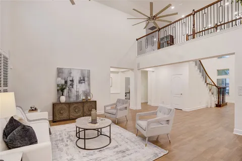 a living room with furniture and a painting on the wall