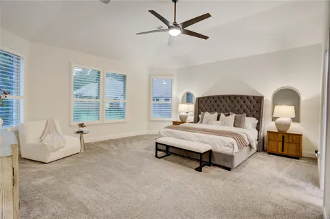 a spacious bedroom with a bed and a couch