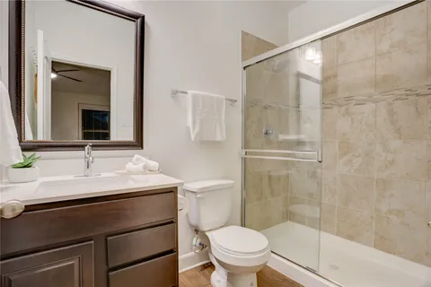 a bathroom with a sink toilet a mirror and shower