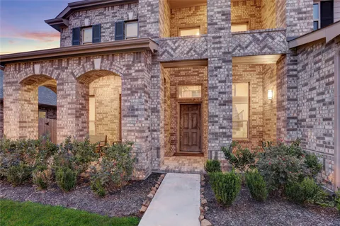 a front view of a house with plants