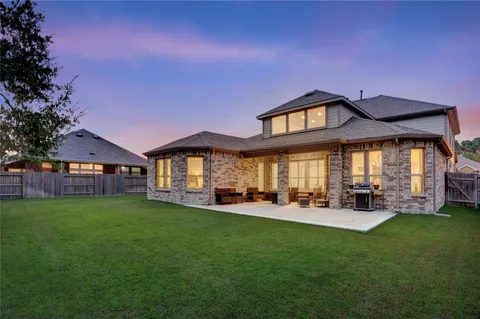 a view of a house with a yard and sitting area