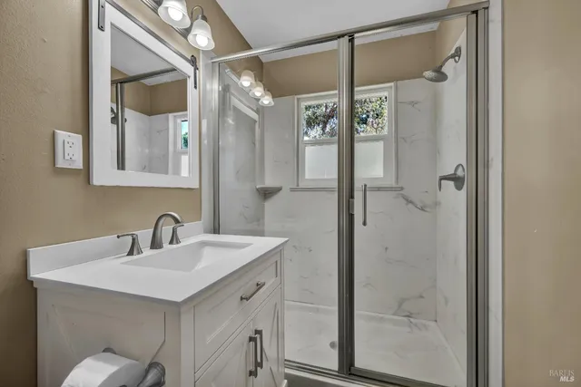 an aerial view of residential houses with outdoor space and trees