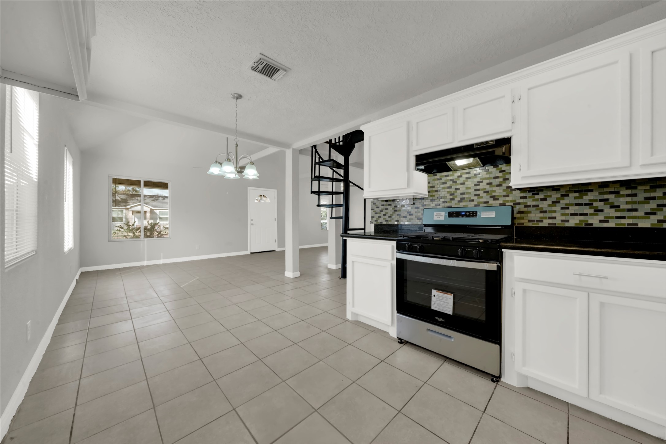 106 Hanover Street Houston, TX 77012 - Photo 12 of 49 a kitchen with stainless steel appliances kitchen island granite countertop a stove a sink and a refrigerator
