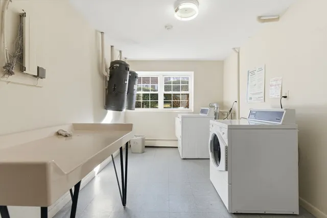 a room with a sink a bed and a large window